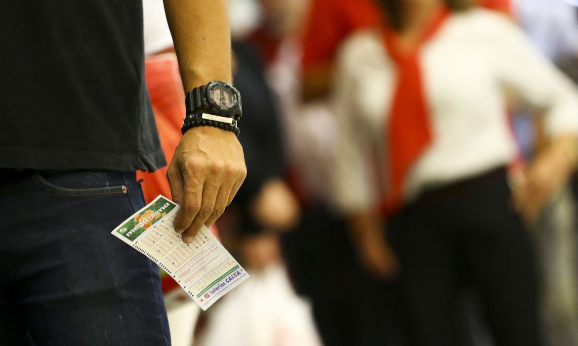 Marcelo Camargo/Agência Brasil Apostadores fazem fila em casa lotérica. A Caixa Econômica Federal sorteia hoje (08) as seis dezenas do concurso 2.149 da Mega-Sena acumulada, que deve pagar um prêmio de R$ 170 milhões.
